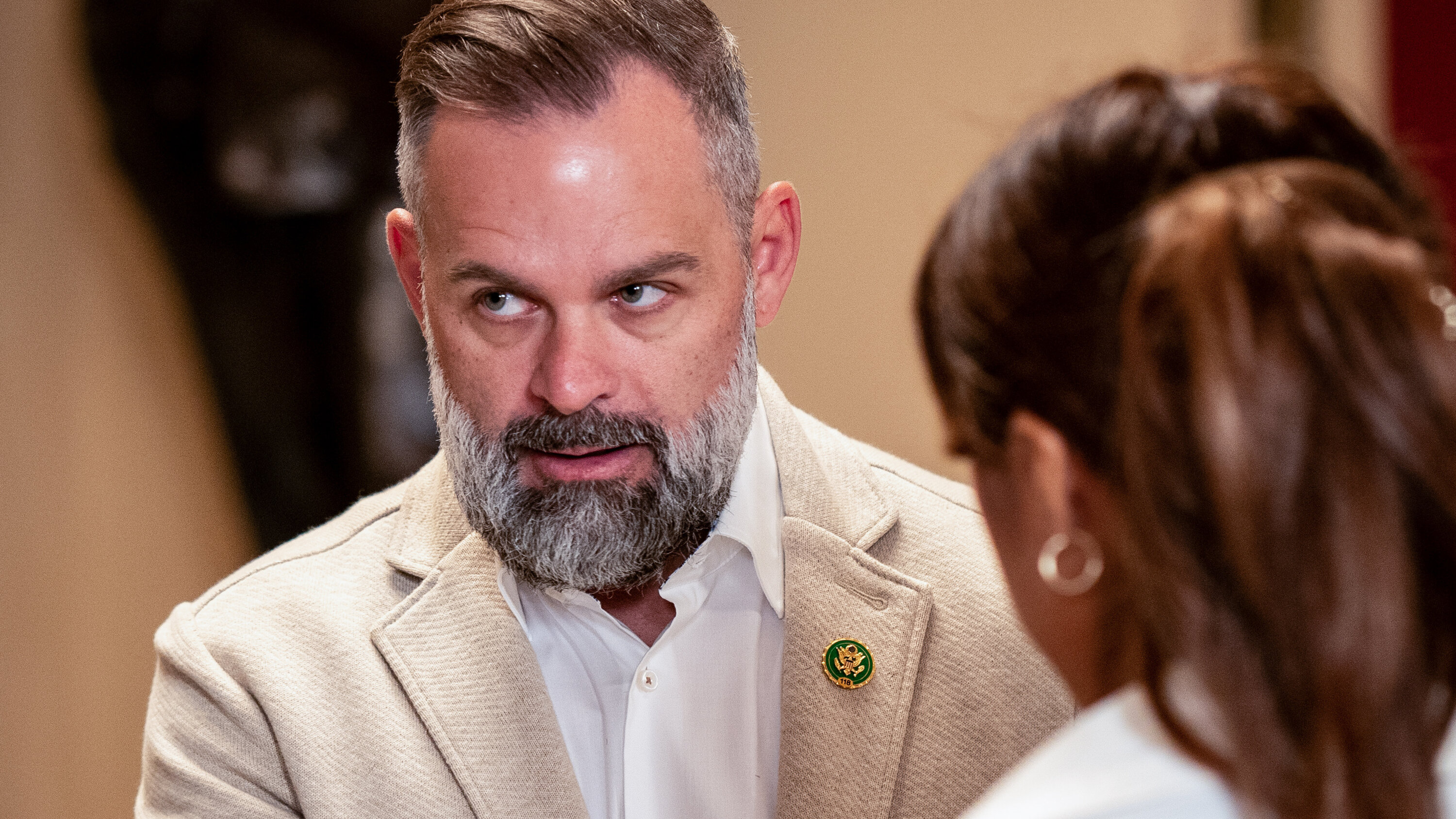 Representative Cory Mills glancing sideways in a Capitol hallway